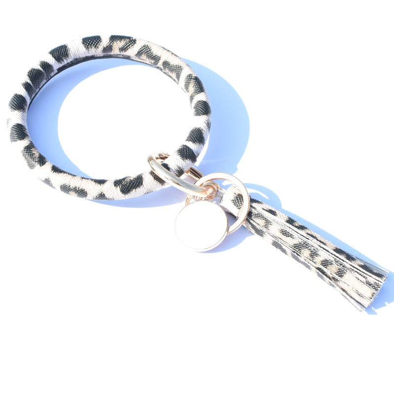 Llavero de muñeca de borla de estampado de leopardo PU al por mayor